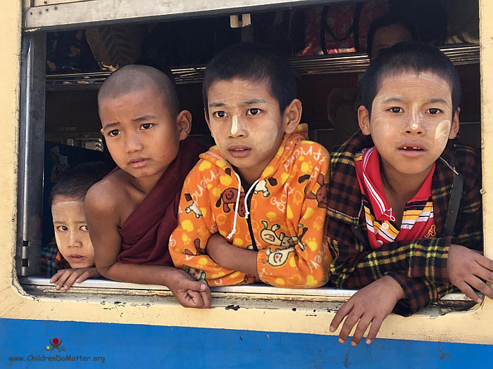 children looking out from the train window - children do matter