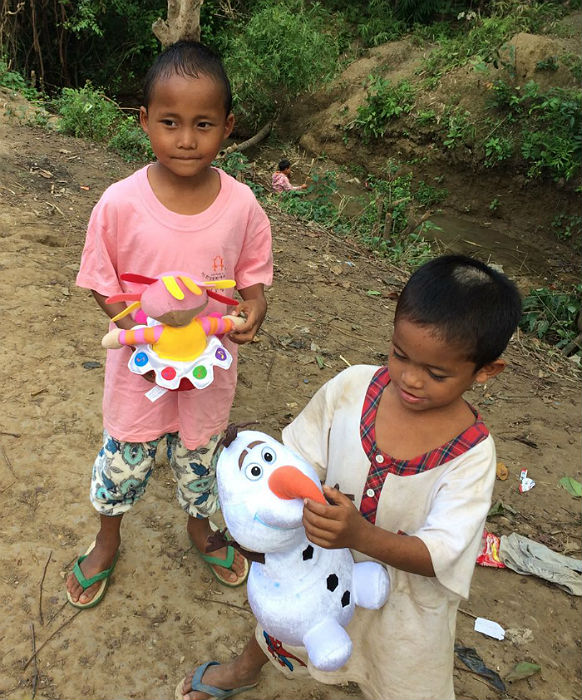 two orphans with toys at sasana orphanage - children do mattter
